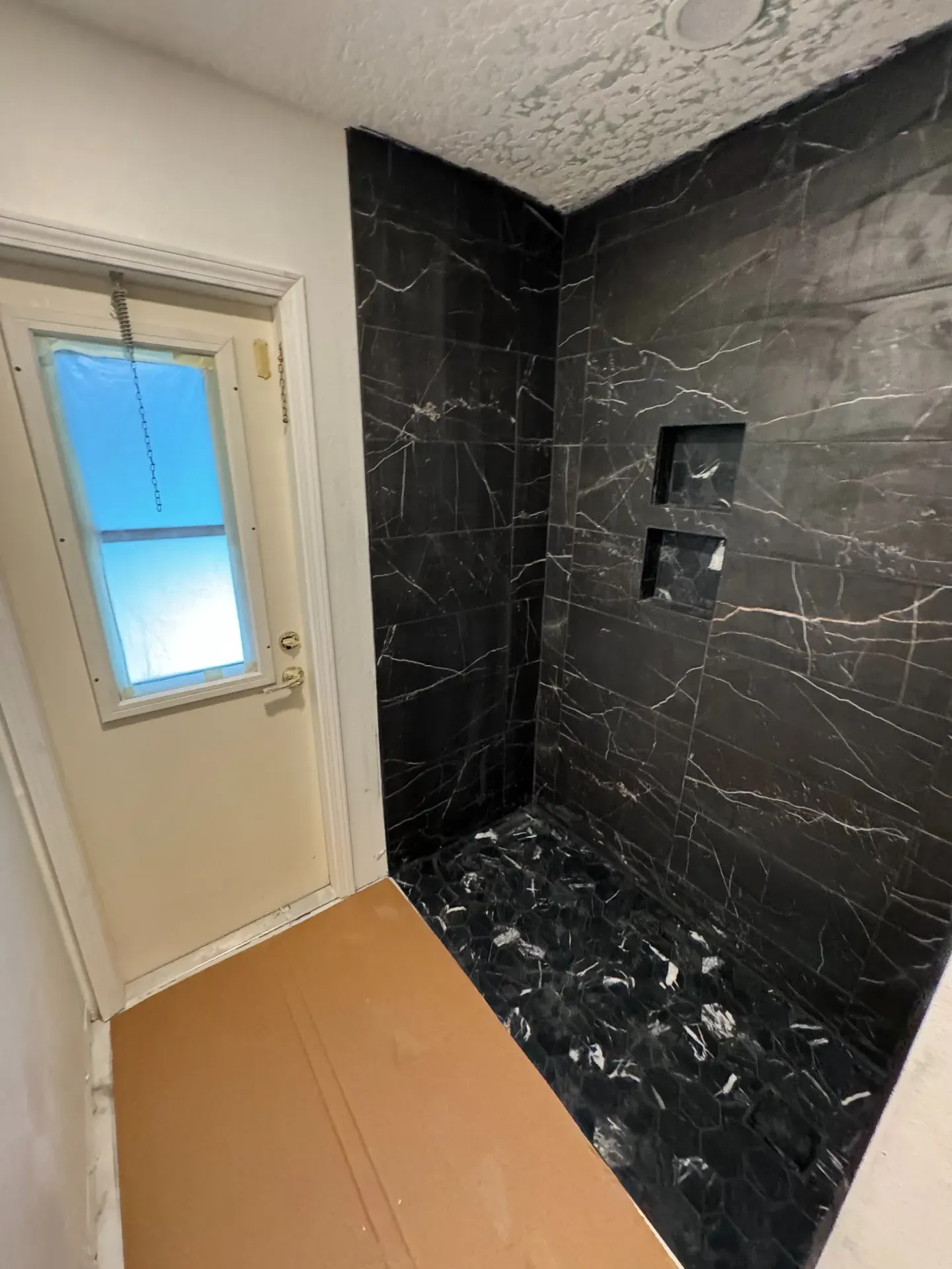 Black marble-look tiled shower