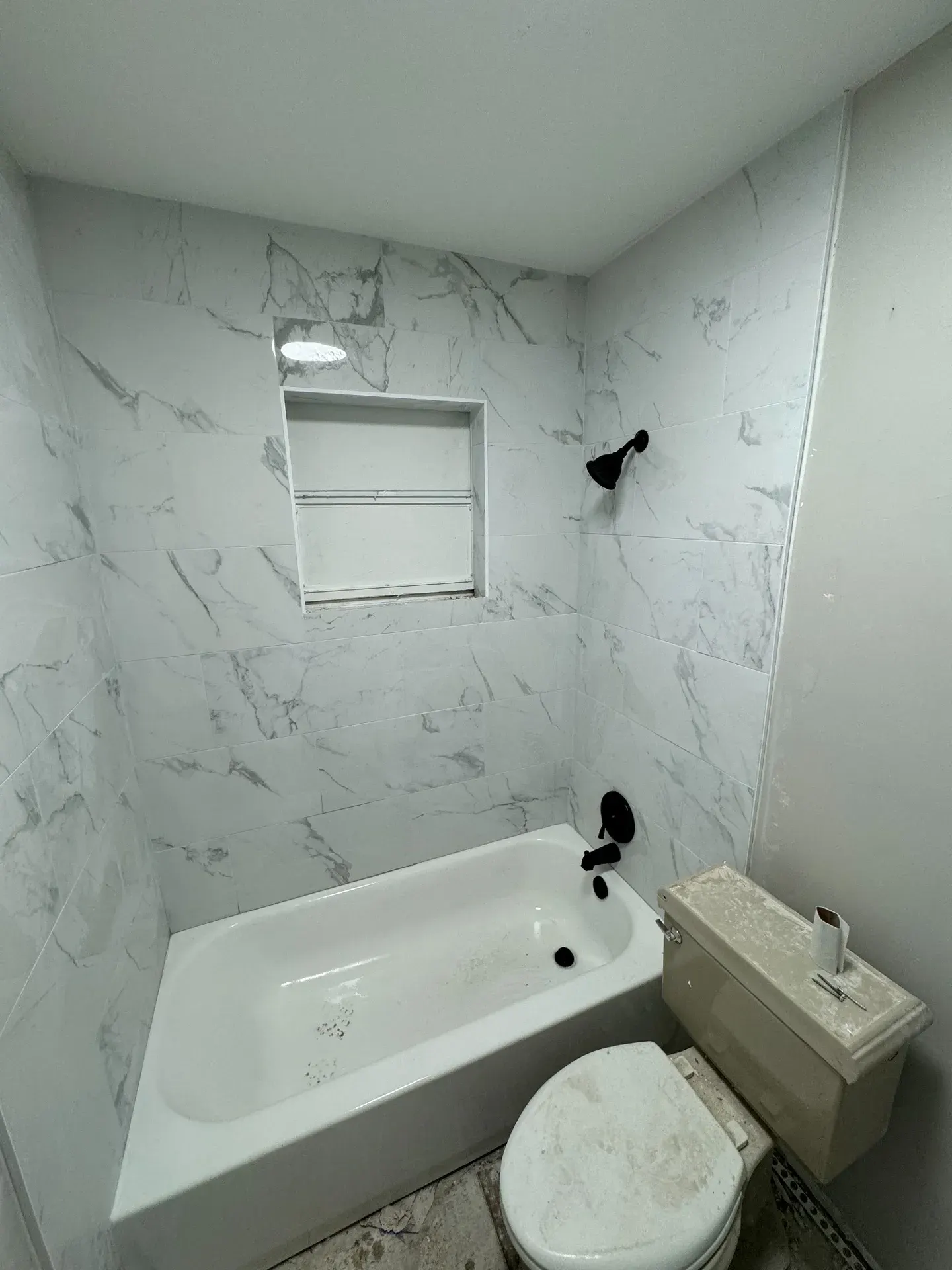 Bathtub with newly installed tile surround